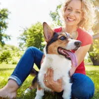 Woman enjoying her outdoor living area with her corgi.